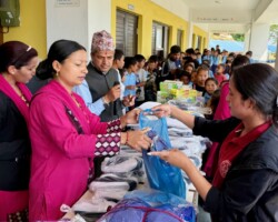 School uniforms and supplies to children in a village school.